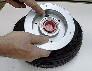 Time to insert the innertube valve into the tire rim grommet